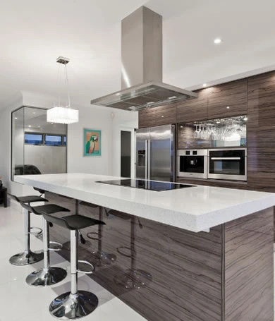 A sleek, modern custom kitchen island with bar stools.